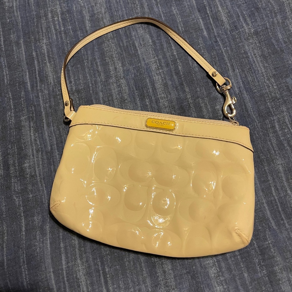 Cream Coach wristlet, shiny